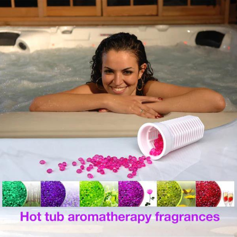 A lady sat in a hot tub leant against the side with the pink aromotherapy beads in front of her. The image also shows the 6 different fragrances available for the tub. 